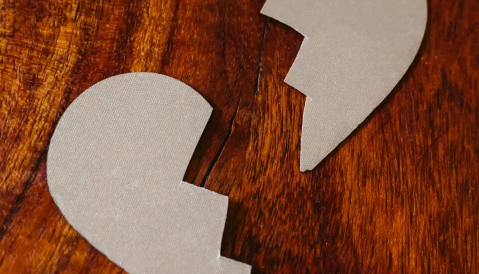 Broken Heart Cardboard on Brown Wooden Table Top